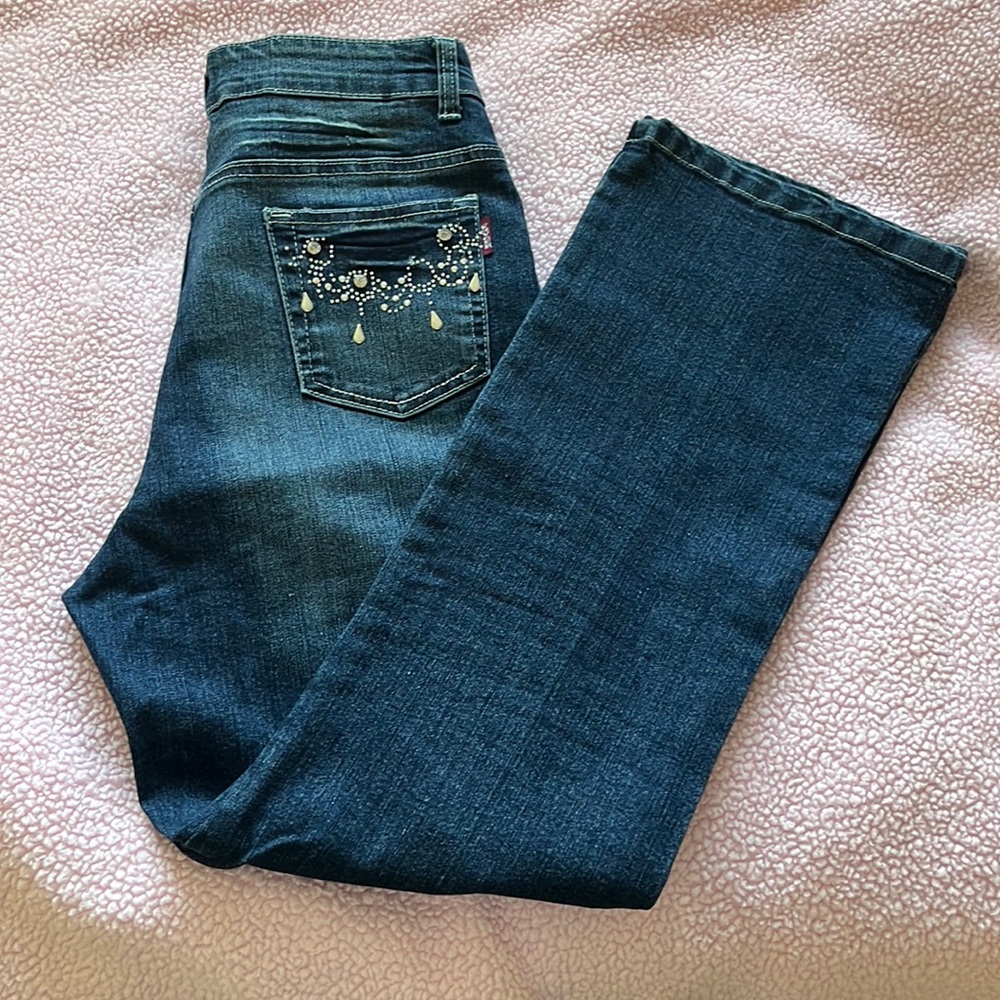 Dark wash jeans with embellished pockets